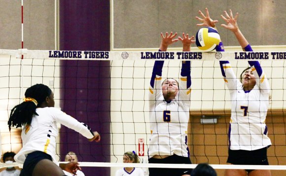 Lemoore's Elizabeth Schalde (6) and Ava Cunningham (7) team up to stop an Edison scoring attempt in Thursday's home volleyball win.